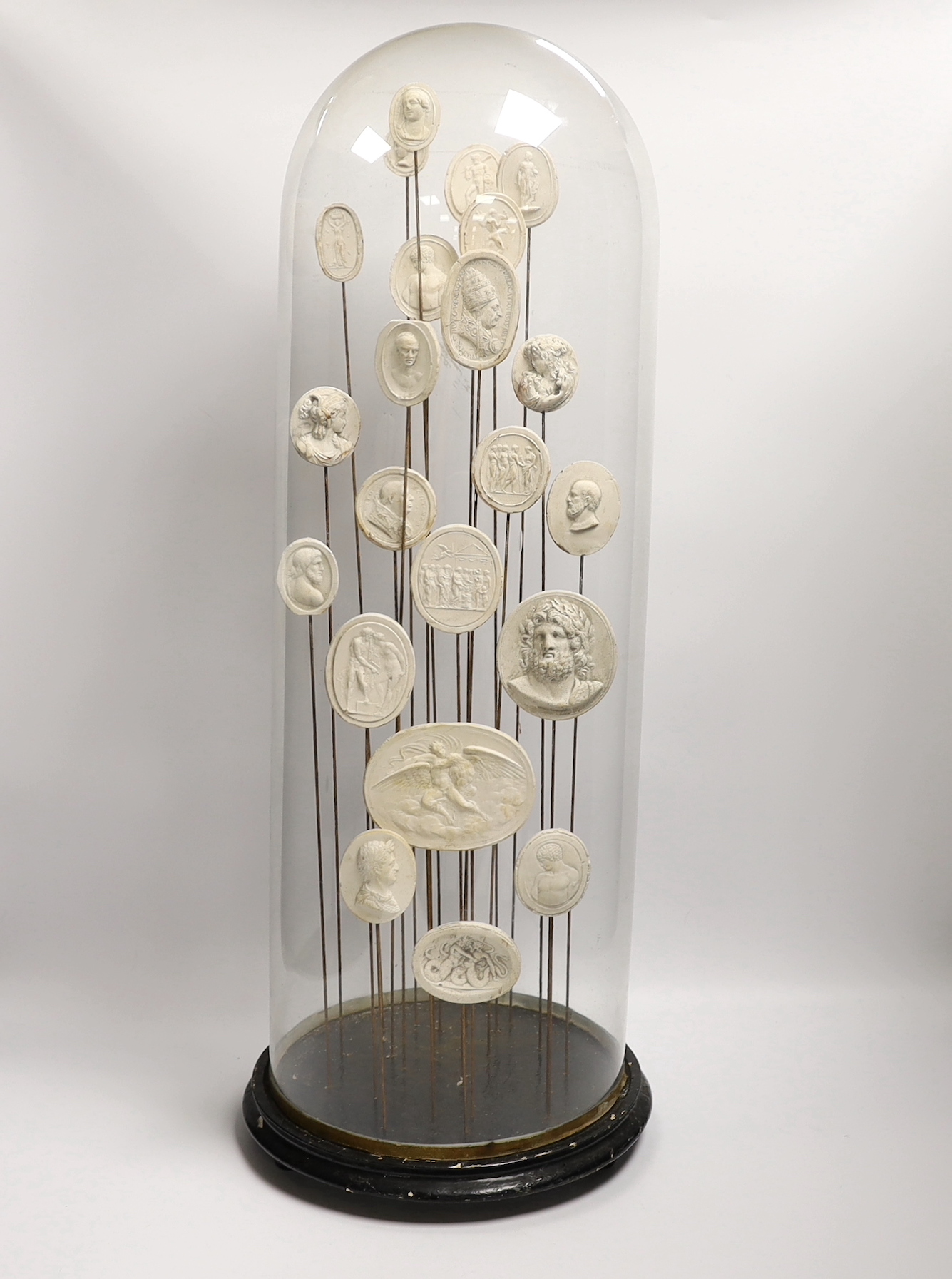 Twenty two Grand Tour intaglio reliefs, under glass dome, height 63cm.
